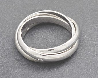 May include: A silver triple band ring with a smooth, polished finish.
