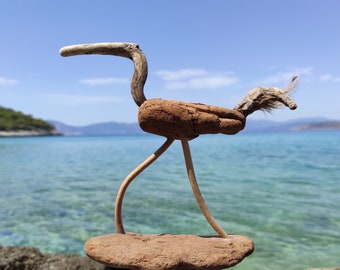 One-of-a-kind driftwood bird sculpture on stand.Beach bird