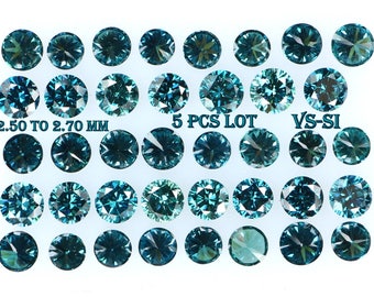 May include: Twenty-five loose blue diamonds arranged in five rows of five. The diamonds are round and measure 2.50 to 2.70 mm. The diamonds are graded VS-SI clarity. The text "5 PCS LOT" is printed on the image.
