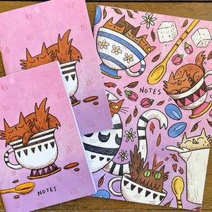Cuaderno con diseño de gato en forma de taza de té, páginas rayadas ilustradas