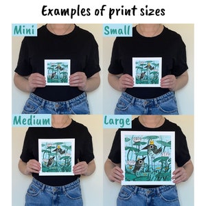 May include: Image demonstrating print sizes: Mini, Small, Medium, and Large. Each print displays a whimsical illustration of birds in a pond with lily pads. The prints are held by a person wearing a black t-shirt and blue jeans. The text at the top reads "Examples of print sizes."