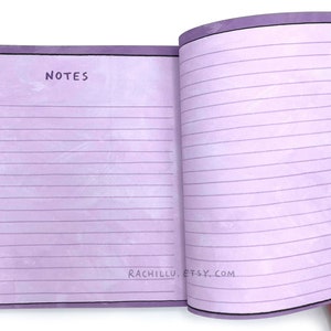 May include: A purple notebook with lined pages and a black border. The front cover has the word "NOTES" written in black. The back cover has the text "RACHILLU. ETSY. COM" written in black.