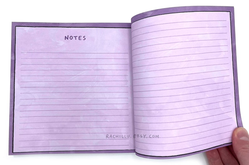 May include: A purple notebook with lined pages and a black border. The front cover has the word "NOTES" written in black. The back cover has the text "RACHILLU. ETSY. COM" written in black.