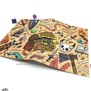 May include: A brown paper journal with a hand-drawn illustration of a treasure chest, swords, bones, and other adventure-themed items. The text "Adventure Journal" is printed on the cover.