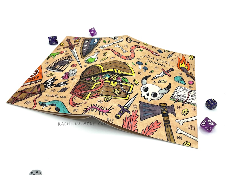 May include: A brown paper journal with a hand-drawn illustration of a treasure chest, swords, bones, and other adventure-themed items. The text "Adventure Journal" is printed on the cover.