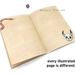 May include: An open notebook with lined pages. The front cover has a red snake illustration and the back cover has a black and white skull illustration. The text "RACHILLU.ETSY.COM" is printed on the back cover. The text "every illustrated page is different!" is printed below the notebook.