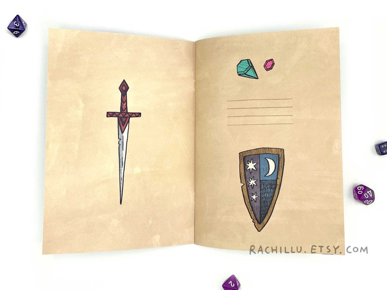 May include: An open notebook with a brown cover. The left page has a drawing of a red and silver sword. The right page has a drawing of a shield with a crescent moon and stars, and two small drawings of gemstones. The text "RACHILLU.ETSY.COM" is printed at the bottom of the right page.