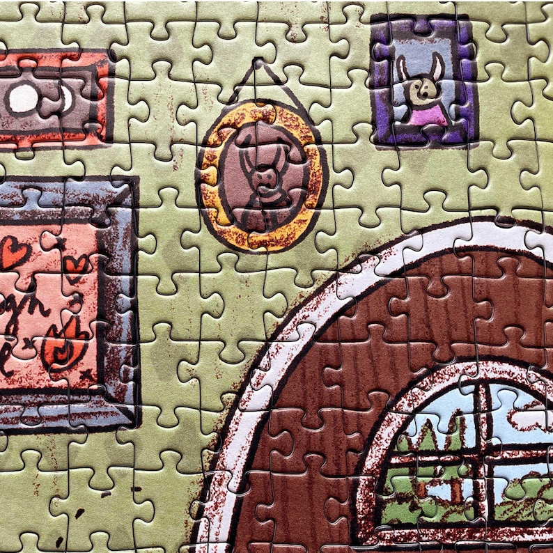 May include: A completed jigsaw puzzle featuring a cartoon illustration of a room interior. The puzzle pieces are primarily green, with brown and orange accents. The image includes framed pictures and a window with a view of trees.