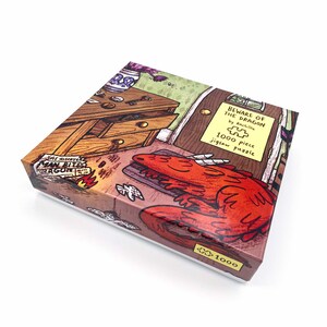 May include: A square jigsaw puzzle box with a colorful illustration. The box features a red dragon, a wooden desk, and the text "BEWARE OF THE DRAGON" and "1000 piece jigsaw puzzle". The box is brown and white.