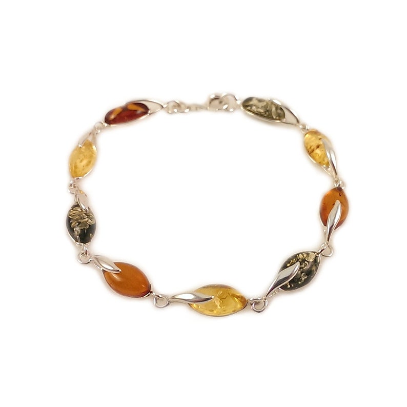 May include: A silver bracelet with amber stones in shades of green, yellow, and brown. The stones are oval shaped and set in a twisted silver design.