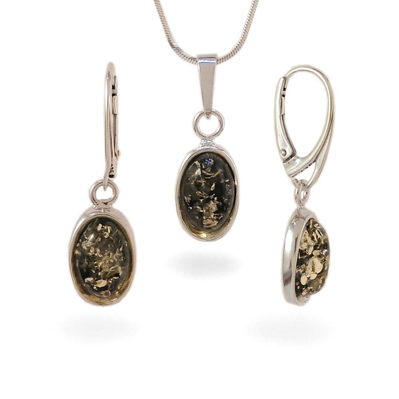 May include: A silver necklace and earrings set with oval green amber stones.