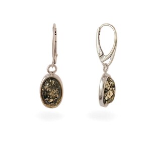 May include: A pair of silver dangle earrings with green amber oval stones.