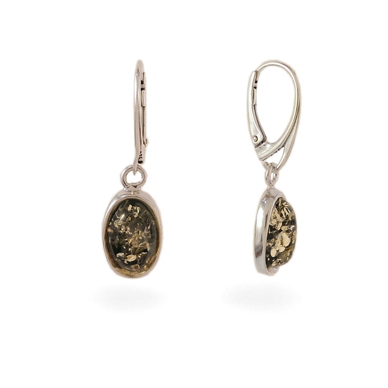 May include: A pair of silver dangle earrings with green amber oval stones.