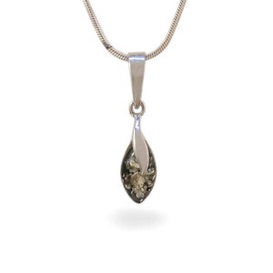 May include: A silver chain necklace with a green amber pendant. The pendant is shaped like a teardrop and has a silver leaf design.