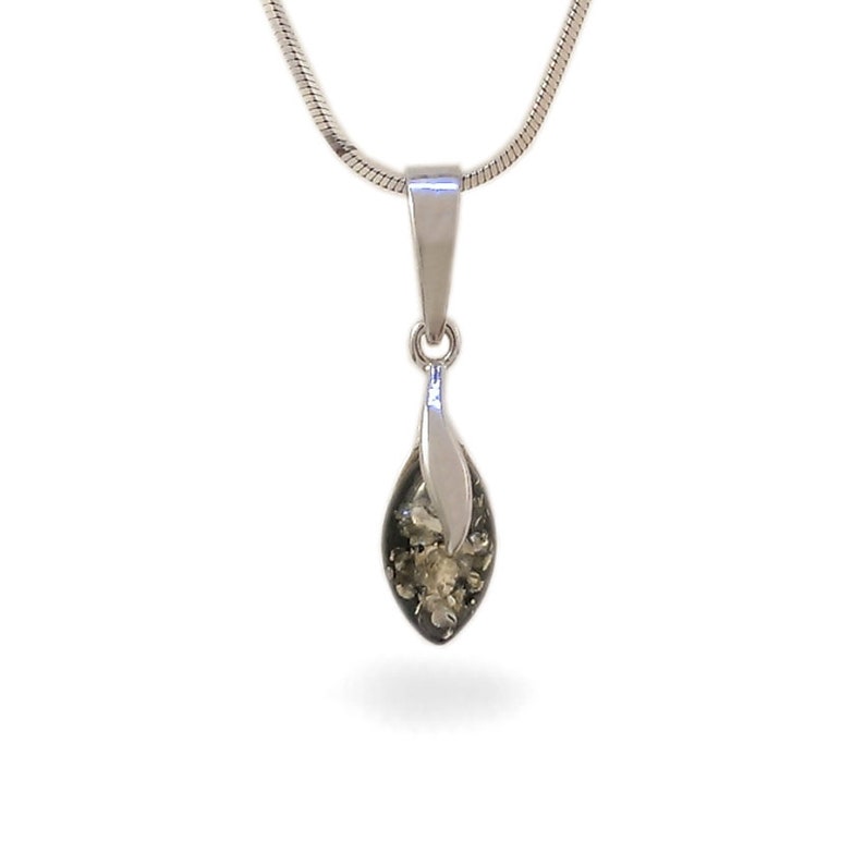 May include: A silver chain necklace with a green amber pendant. The pendant is shaped like a teardrop and has a silver leaf design.