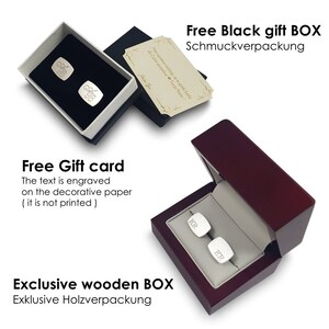 May include: Two pairs of silver cufflinks in a black gift box with a white interior. The cufflinks are engraved with the letters "KR". The box also includes a free gift card with the text "Free Gift card. The text is engraved on the decorative paper (it is not printed)".