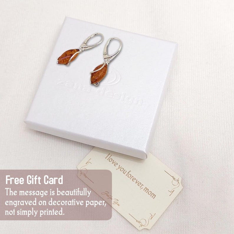 May include: A pair of silver earrings with amber stones. The earrings are in a white box with a gift card that says "I love you forever, mom".