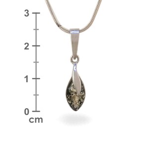 May include: A silver pendant with a green amber stone in the shape of a teardrop. The pendant is approximately 2 cm long.