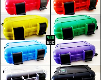 May include: A set of ten small, rectangular, waterproof cases in various colors, including red, orange, yellow, green, blue, purple, silver, and black. Each case has a black latch and the text "420 EDC" is printed on two of the cases.