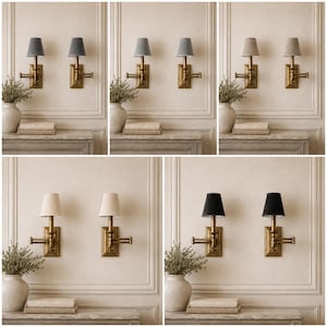 May include: A collection of five pairs of wall-mounted swing arm lamps featuring brass hardware and fabric shades in various neutral tones including grey, beige, and black, each mounted on a rectangular backplate with an adjustable arm.