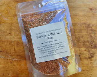 May include: A clear plastic bag filled with a blend of spices labeled "Turkey & Chicken Rub." The label lists ingredients like brown sugar, paprika, and rosemary. The bag is on a wooden surface.