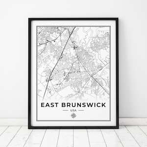May include: Black and white map print of East Brunswick, USA. The map shows the streets and roads of the city. The print is framed in a black frame.