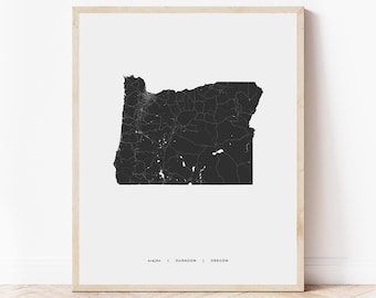 May include: A black and white print of a map of Oregon with the text "oregon | OURACON | OREGON" at the bottom.