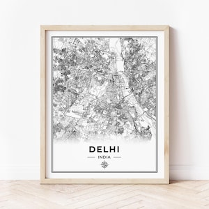 May include: Black and white map print of Delhi, India in a wooden frame. The map shows the city streets and landmarks. The text "DELHI" and "INDIA" is printed below the map.