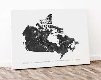 May include: Black and white print of a map of Canada with the text "KANATA | LE PAYS DES CANADAS | DOMINION OF CANADA | CANADA" at the bottom.
