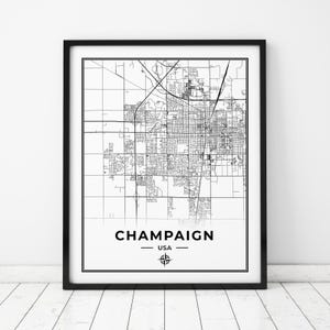 May include: Black and white map print of Champaign, Illinois, USA. The map shows the city streets and landmarks. The city name is printed below the map with the word "USA" underneath.