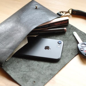 Minimalist black leather wallet with wristlet. Small handmade carry-all bag. Unlined soft Italian leather.