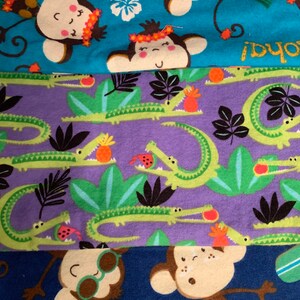 May include: Three different fabric swatches with various patterns. The top swatch is blue with a white and yellow pineapple design and monkeys wearing leis. The middle swatch is purple with a green alligator pattern. The bottom swatch is blue with a monkey wearing sunglasses and a crab design.