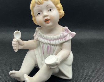 Vintage Porcelain Piano Baby Girl with porridge bowl and spoon