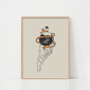 May include: A black and white illustration of a skeletal hand holding a glass bottle with a black liquid and a small plant inside. The bottle is tied with an orange ribbon that reads "Plant Potion".