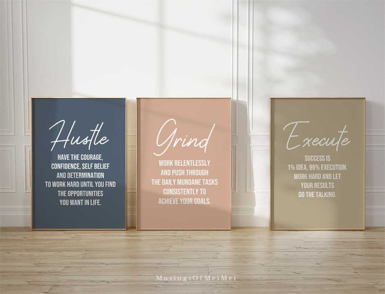 May include: Three motivational posters with a light blue, light pink, and light brown background. The posters have white text that reads "Hustle", "Grind", and "Execute". The text on the posters is in a bold, sans-serif font.