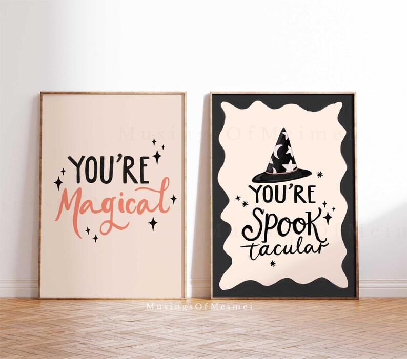 May include: Two printable Halloween-themed posters with black text on a light pink background. The first poster says "You're Magical" with black stars. The second poster says "You're Spooktacular" with a black witch hat and stars.