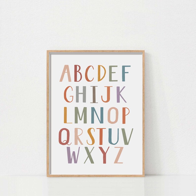 May include: A framed print with the alphabet in colorful letters on a white background. The letters are in a rainbow of colors, including red, orange, yellow, green, blue, purple, and brown.