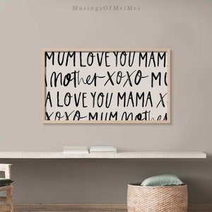 May include: A framed print with black text on a white background. The text reads "MUM LOVE YOU MAM Mother Xoxo MI A LOVE YOU MAMA X Xoxo MUM Mother".