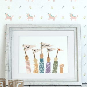 May include: Framed art print with the words "ALL ARE WELCOME HERE" on pennant flags held by diverse hands. The hands have various sleeve patterns. The background features a unicorn and floral pattern.