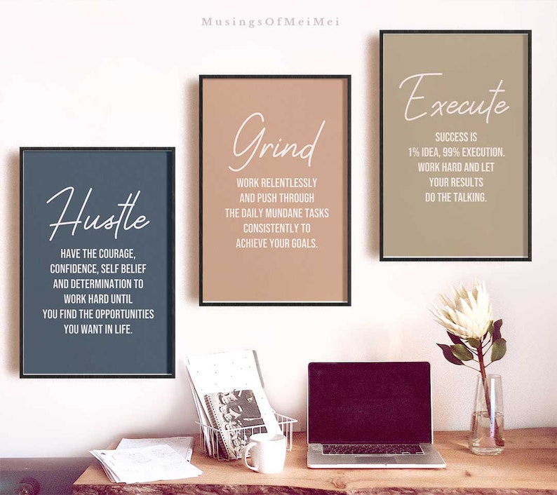 May include: Three motivational posters with inspirational quotes. The posters are framed in black and have a light brown, beige, and dark blue background. The quotes are "Hustle", "Grind", and "Execute".