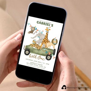 May include: A digital invitation displayed on a smartphone screen featuring a watercolor illustration of a green safari jeep carrying a tiger, elephant, giraffe, lion, and monkey wearing party hats. Text reads: Join us to celebrate GABRIEL'S Wild One! SATURDAY, JUNE 28th | 12 - 4PM GABRIEL'S HOUSE 501 Safari Drive, Irvine, CA rsvp to Rachel at 0432 256 090.