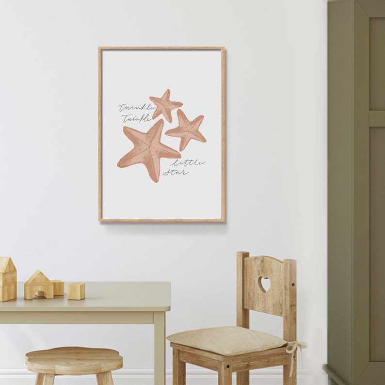 May include: A framed print with a light brown background featuring three starfish and the text "Twinkle Twinkle Little Star".