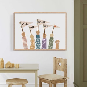 May include: A framed art print featuring raised hands holding flags that read "ALL ARE WELCOME HERE." The hands have various sleeve patterns, and one has a paw print. The artwork is in a light wood frame, suitable for a child's room or a welcoming space.