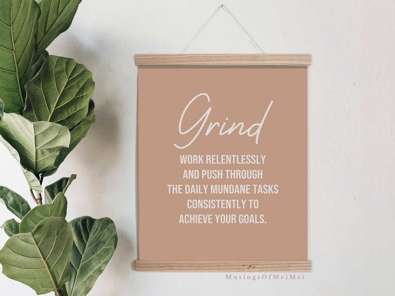 May include: A motivational quote poster with a beige background and white text. The quote reads "Grind Work relentlessly and push through the daily mundane tasks consistently to achieve your goals." The poster also includes the text "Musings OfMeiMei" at the bottom.