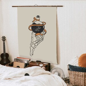 May include: A beige tapestry with a skeletal hand holding a glass bottle with a black liquid and a small sprig of leaves. The bottle is tied with a ribbon that reads "PLANT POISON".