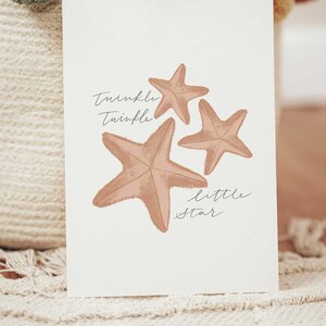 May include: A white card with three brown starfish and the text "Twinkle Twinkle Little Star" in black cursive writing.