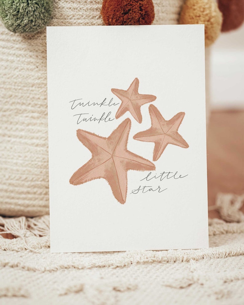 May include: A white card with three brown starfish and the text "Twinkle Twinkle Little Star" in black cursive writing.