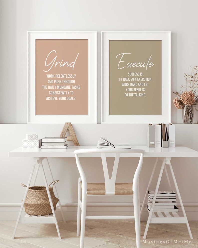 May include: Two framed motivational posters with beige and brown backgrounds. The left poster has the word "Grind" in white script and the text "Work relentlessly and push through the daily mundane tasks consistently to achieve your goals." The right poster has the word "Execute" in white script and the text "Success is 1% idea, 99% execution. Work hard and let your results do the talking."