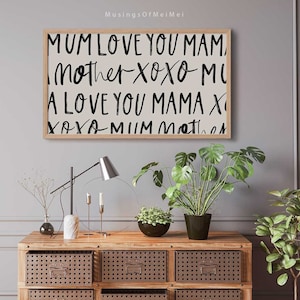 May include: A framed print with a white background and black text that reads "MUM LOVE YOU MAM, Mother XOXO MI, A LOVE YOU MAMA X, XOXO MUM Mother".