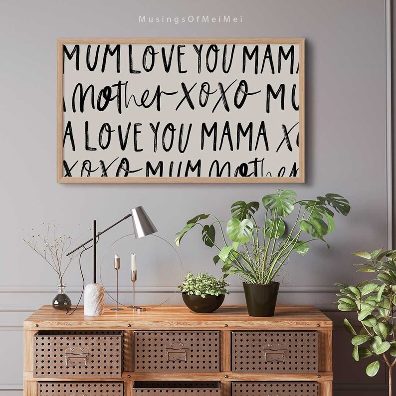 May include: A framed print with a white background and black text that reads "MUM LOVE YOU MAM, Mother XOXO MI, A LOVE YOU MAMA X, XOXO MUM Mother".